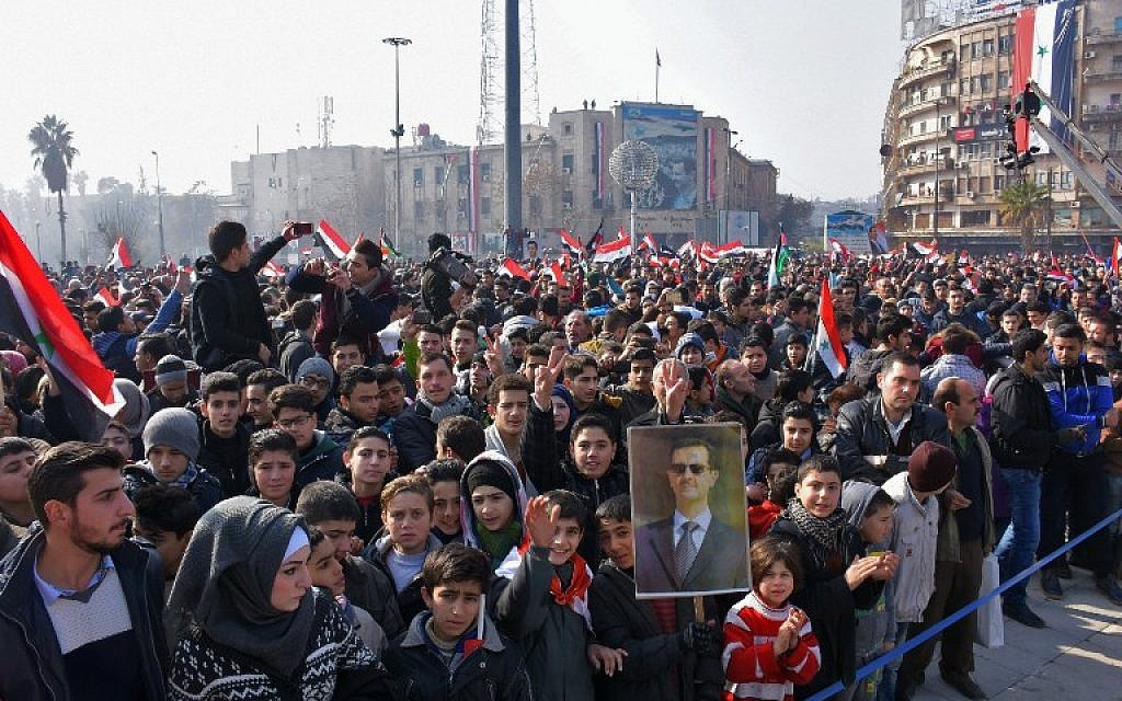 Syrians wave the national flag during a gathering in Aleppo's Saadallah al-Jabiri Square on January 19, 2017, to express their support for President Bashar Assad. (AFP PHOTO/George OURFALIAN) Syrians wave the national flag during a gathering in Aleppo's Saadallah al-Jabiri Square on January 19, 2017, to express their support for President Bashar Assad. (AFP PHOTO/George OURFALIAN)
