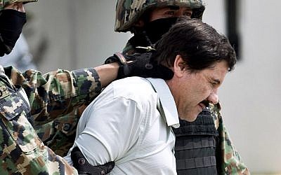 This file photo taken on February 22, 2014 shows Mexican drug trafficker Joaquin 'El Chapo' Guzman being escorted by marines in Mexico City following his arrest at a resort in Mazatlan, northern Mexico. (AFP PHOTO/RONALDO SCHEMIDT)