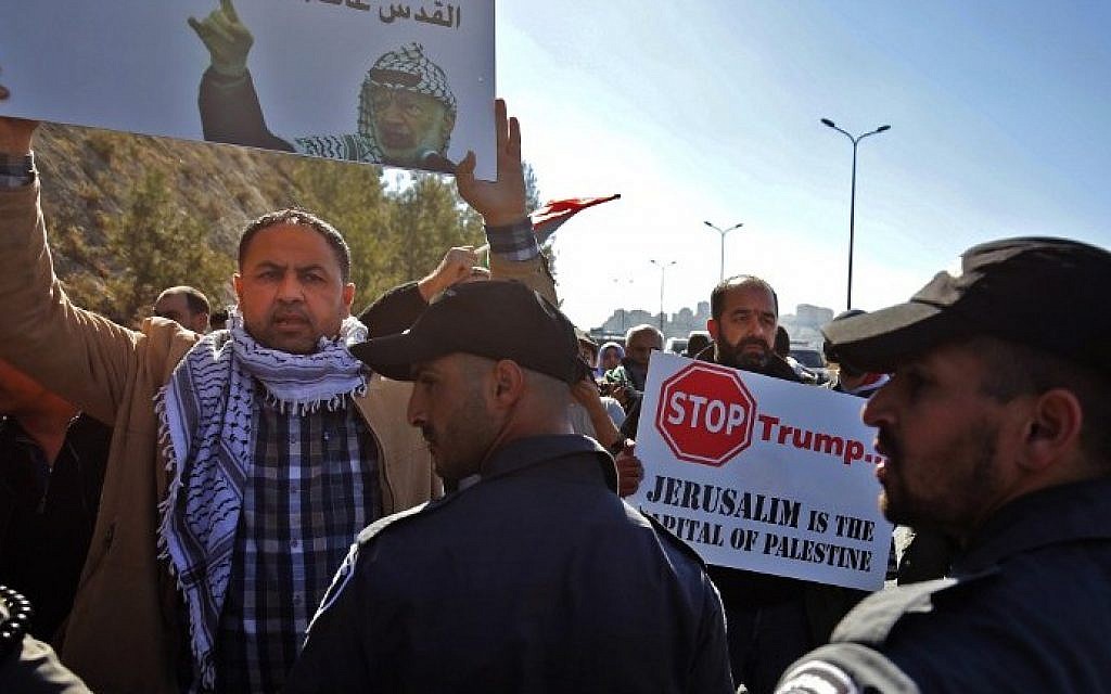 Palestinian protesters hold placards during a demonstration east of Jerusalem against US President-elect Donald Trump, on January 20, 2017 (AFP PHOTO / ABBAS MOMANI) Palestinian protesters hold placards during a demonstration east of Jerusalem against US President-elect Donald Trump, on January 20, 2017 (AFP PHOTO / ABBAS MOMANI)