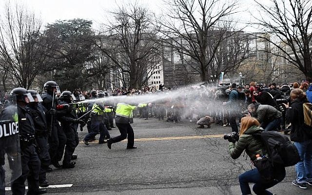 Police pepper spray anti-Trump protesters during clashes in Washington, DC, January 20, 2017. (AFP/Jewel SAMAD) Police pepper spray anti-Trump protesters during clashes in Washington, DC, January 20, 2017. (AFP/Jewel SAMAD)
