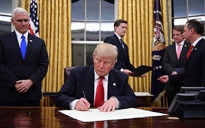 US President Donald Trump signs a confirmation for John Kelly as US Secretary of Homeland Security, as Vice President Mike Pence, left, and White House Chief of Staff Reince Priebus, right, look on, in the Oval Office of the White House in Washington, DC, January 20, 2017. AFP/ JIM WATSON) US President Donald Trump signs a confirmation for John Kelly as US Secretary of Homeland Security, as Vice President Mike Pence, left, and White House Chief of Staff Reince Priebus, right, look on, in the Oval Office of the White House in Washington, DC, January 20, 2017. AFP/ JIM WATSON)