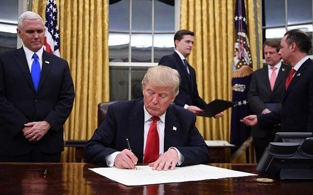 US President Donald Trump signs a confirmation for John Kelly as US Secretary of Homeland Security, as Vice President Mike Pence, left, and White House Chief of Staff Reince Priebus, right, look on, in the Oval Office of the White House in Washington, DC, January 20, 2017. AFP/ JIM WATSON) US President Donald Trump signs a confirmation for John Kelly as US Secretary of Homeland Security, as Vice President Mike Pence, left, and White House Chief of Staff Reince Priebus, right, look on, in the Oval Office of the White House in Washington, DC, January 20, 2017. AFP/ JIM WATSON)