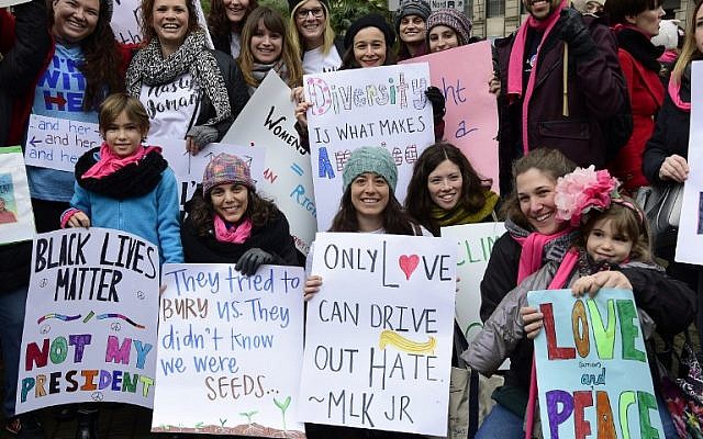 People pose with placards in central Barcelona on January 21, 2017 in a mark of solidarity for the political rally promoting the rights and equality for women, Women's March on Washington. (AFP PHOTO/LLUIS GENE) People pose with placards in central Barcelona on January 21, 2017 in a mark of solidarity for the political rally promoting the rights and equality for women, Women's March on Washington. (AFP PHOTO/LLUIS GENE)