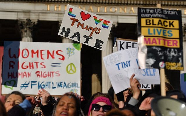 Protesters hold placards during the Women's March in Trafalgar Square in London on January 21, 2017 as part of a global day of protests against new US President Donald Trump. (AFP PHOTO/BEN STANSALL)