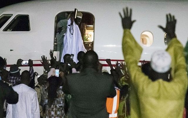 Former president Yaya Jammeh (C,up), the Gambia's leader for 22 years, waves from the plane as he leaves the country on 21 January 2017 in Banjul. (AFP PHOTO / STRINGER) Former president Yaya Jammeh (C,up), the Gambia's leader for 22 years, waves from the plane as he leaves the country on 21 January 2017 in Banjul. (AFP PHOTO / STRINGER)