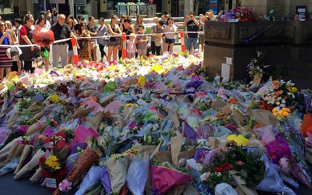 Two days after a man went on a rampage in a car killing five, visitors lay flowers at a floral tribute on Bourke street in Melbourne, January 22, 2017. (AFP/Saeed KHAN) Two days after a man went on a rampage in a car killing five, visitors lay flowers at a floral tribute on Bourke street in Melbourne, January 22, 2017. (AFP/Saeed KHAN)