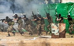 Members of the Palestinian terror group Hamas's security forces stage a mock raid on IDF post during a graduation ceremony in Gaza City on January 22, 2017. (Mahmud Hams/AFP)