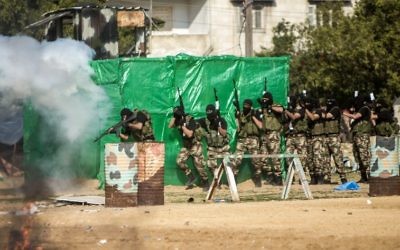 Members of the Palestinian Hamas security forces stage mock raid on IDF post during a graduation ceremony in Gaza City on January 22, 2017. (AFP PHOTO / MAHMUD HAMS)
