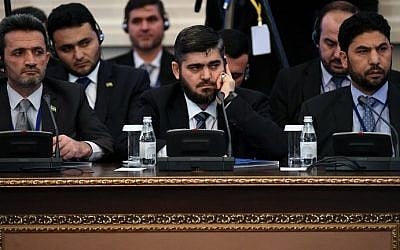 Then chief opposition negotiator Mohammad Alloush (C) of the Jaish al-Islam (Army of Islam) rebel group attends the first session of Syria peace talks at Astana's Rixos President Hotel on January 23, 2017. (AFP Photo/Kirill Kudryavtsev) Then chief opposition negotiator Mohammad Alloush (C) of the Jaish al-Islam (Army of Islam) rebel group attends the first session of Syria peace talks at Astana's Rixos President Hotel on January 23, 2017. (AFP Photo/Kirill Kudryavtsev)