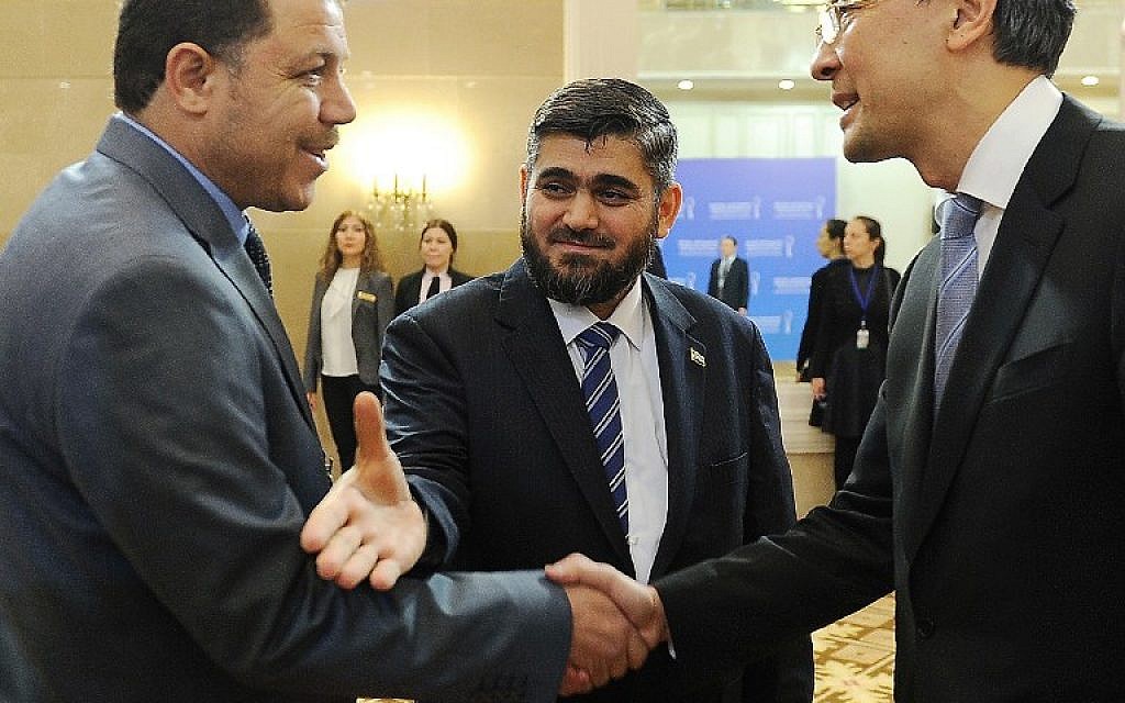 Chief opposition negotiator Mohammad Alloush, center, of the Jaish al-Islam (Army of Islam) rebel group arrives to attend the first session of Syria peace talks at Astana's Rixos President Hotel on January 23, 2017. (AFP/Ilyas Omarov)