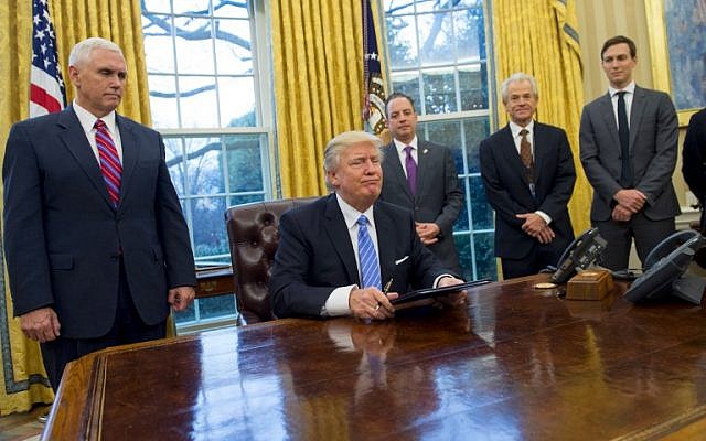 US President Donald Trump sits in the Oval Office after signing executive orders withdrawing the US from the Trans-Pacific Partnership trade deal, freezing the hiring of federal workers and hitting foreign NGOs that help with abortion, on January 23, 2017. (AFP PHOTO/SAUL LOEB)