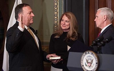 US Vice President Mike Pence, right, swears in Mike Pompeo as CIA director as his wife Susan looks on in the Vice President's Ceremonial Office at the Eisonhower Executive Office Building on January 23, 2017 in Washington, DC. (AFP/ NICHOLAS KAMM)