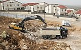 Palestinian laborers work at the construction site of a new housing project in the Israeli settlement of Ariel near the West Bank city of Nablus on January 25, 2017. (AFP Photo/Jack Guez)