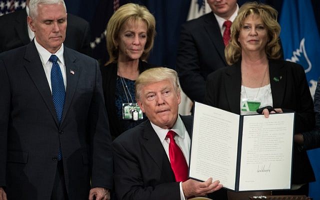 US President Donald Trump holds up an executive order to start the Mexico border wall project at the Department of Homeland Security facility in Washington, DC, on January 25, 2017. (AFP/Nicholas Kamm) US President Donald Trump holds up an executive order to start the Mexico border wall project at the Department of Homeland Security facility in Washington, DC, on January 25, 2017. (AFP/Nicholas Kamm)