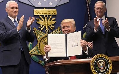 US-POLITICS-DEFENSE-TRUMP-MATTIS US President Donald Trump holds up an executive action on rebuilding the armed forces after signing it on January 27, 2017 at the Pentagon in Washington, DC. Looking on are US Vice President Mike Pence (L) and US Defense Secretary James Mattis. AFP PHOTO / MANDEL NGAN)