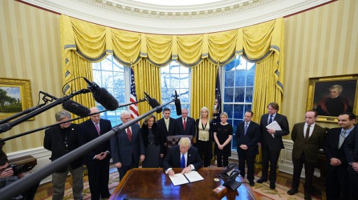 US President Donald Trump signs an executive memorandum on defeating the Islamic State in Iraq and Syria after signing it in the Oval Office of the White House on January 28, 2017, in Washington, DC. (AFP/MANDEL NGAN) US President Donald Trump signs an executive memorandum on defeating the Islamic State in Iraq and Syria after signing it in the Oval Office of the White House on January 28, 2017, in Washington, DC. (AFP/MANDEL NGAN)