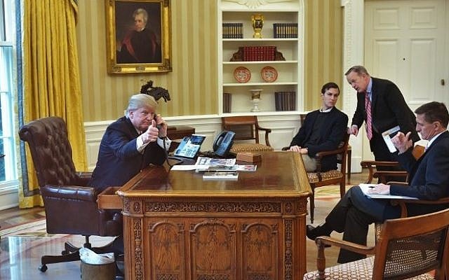 US President Donald Trump seen through an Oval Office window gives a thumbs up as he speaks on the phone to King Salman of Saudi Arabia in the Oval Office of the White House on January 29, 2017 in Washington, DC. (AFP PHOTO / MANDEL NGAN)