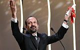 Iranian director Asghar Farhadi celebrating on stage after being awarded with the Best Screenplay prize for the film "The Salesman (Forushande) during the closing ceremony of the 69th Cannes Film Festival in Cannes, southern France, May 22, 2016. (AFP PHOTO / Valery HACHE)