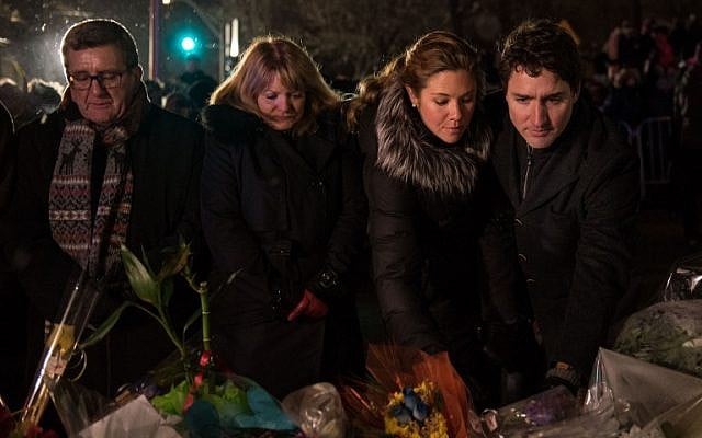 (L-R) Quebec city mayor Regis Labeaume, his wife, Sophie Gregoire (Justin Trudeau's wife) and Canadian prime minister Justin Trudeau lay flowers near the Islamic Cultural Center in Quebec City, Canada on January 30, 2017.(AFP PHOTO / Alice Chiche) (L-R) Quebec city mayor Regis Labeaume, his wife, Sophie Gregoire (Justin Trudeau's wife) and Canadian prime minister Justin Trudeau lay flowers near the Islamic Cultural Center in Quebec City, Canada on January 30, 2017.(AFP PHOTO / Alice Chiche)