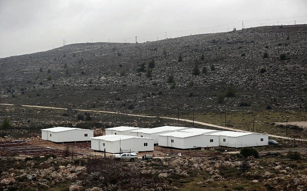 New prefabricated homes are seen under construction in the West Bank between the Israeli outpost of Amona (background) and the Israeli settlement of Ofra, north of Ramallah, on January 31, 2017. ( AFP PHOTO / THOMAS COEX)