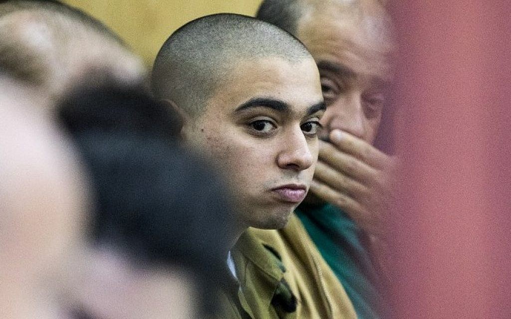 IDF soldier Elor Azaria, center, who shot dead a wounded Palestinian assailant, arrives at the military court in Tel Aviv on January 31, 2017. (AFP Photo/Jack Guez)