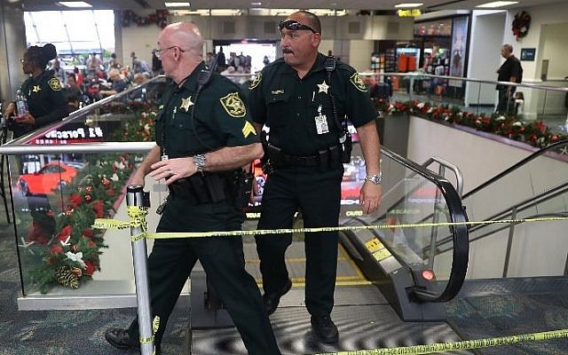 Broward County Sheriff officers exit from the escalator that takes people from the baggage area of Terminal 2 where a shooter killed five people and wounded six others before he was taken into custody, at the Fort Lauderdale-Hollywood International airport on January 7, 2017 in Fort Lauderdale, Florida. Joe Raedle/Getty Images/AFP)