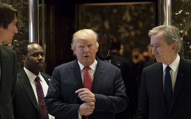 President-elect Donald Trump and French businessman Bernard Arnault, chief executive officer of LVMH, emerge from the elevators to speak to reporters at Trump Tower, January 9, 2017 in New York City. (Drew Angerer/Getty Images/AFP) President-elect Donald Trump and French businessman Bernard Arnault, chief executive officer of LVMH, emerge from the elevators to speak to reporters at Trump Tower, January 9, 2017 in New York City. (Drew Angerer/Getty Images/AFP)