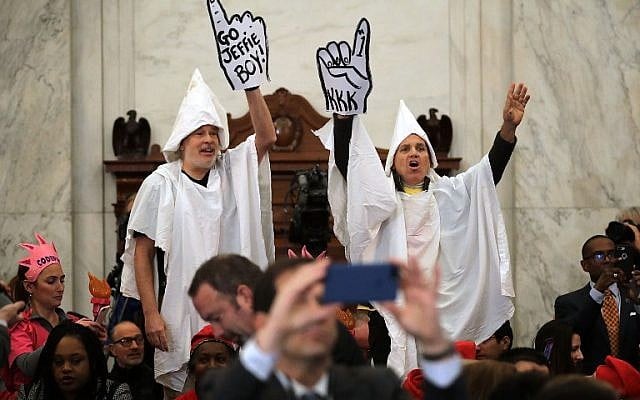 Protesters wearing white sheets shout at Sen. Jeff Sessions (R-AL) as he arrives for his confirmation hearing to be the US attorney general on 10, 2017 in Washington, DC. (Somodevilla/Getty Images/AFP)