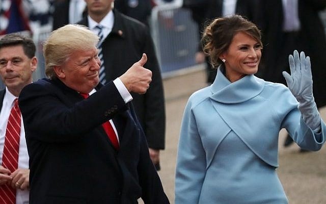US President Donald Trump (L) waves to supporters as he walks the parade route with first lady Melania Trump during the Inaugural Parade on January 20, 2017 in Washington, DC. (Drew Angerer/Getty Images/AFP)