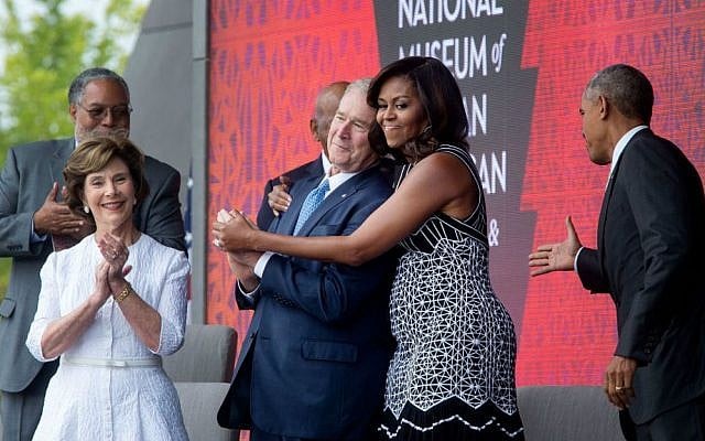 'The First Lady hugs former president George W. Bush as she and President Obama take the stage during the opening ceremony of the Smithsonian National Museum of African American History and Culture in Washington, DC,' Sept. 24, 2016. (Official White House photo/Chuck Kennedy)