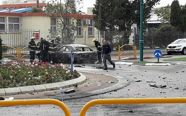 Firefighters on the scene of a car explosion on Jabotinsky Street in Kiryat Yam on January 26, 2017. One person was killed, two were injured in the incident. (Ichud Hatzala Carmel)
