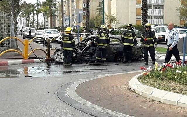 Firefighters at the scene of a car explosion in Kiryat Yam on January 26, 2017. One person was killed, two were injured in the incident.  (United Hatzala Carmel)