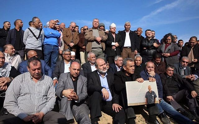 MK Ayman Odeh (back row, with white bandage on head) of the Joint List and other Arab Israeli leaders stand at the scene of fatal clashes in the Bedouin village of Umm al-Hiran, on Wednesday, January 18, 2017 (courtesy) MK Ayman Odeh (back row, with white bandage on head) of the Joint List and other Arab Israeli leaders stand at the scene of fatal clashes in the Bedouin village of Umm al-Hiran, on Wednesday, January 18, 2017 (courtesy)