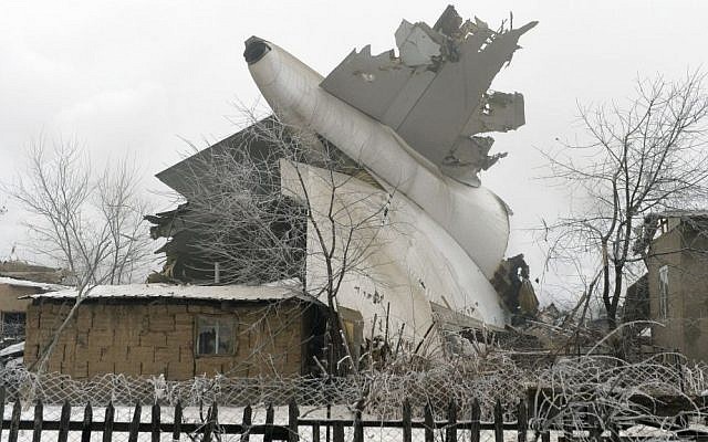The tail of a crashed Turkish Boeing 747 cargo plane lies at a residential area outside Bishkek, Kyrgyzstan Monday, Jan. 16, 2017. The cargo plane crashed Monday morning, killing people in the residential area adjacent to the Manas airport as well as those on the plane. (AP Photo/Vladimir Voronin) The tail of a crashed Turkish Boeing 747 cargo plane lies at a residential area outside Bishkek, Kyrgyzstan Monday, Jan. 16, 2017. The cargo plane crashed Monday morning, killing people in the residential area adjacent to the Manas airport as well as those on the plane. (AP Photo/Vladimir Voronin)