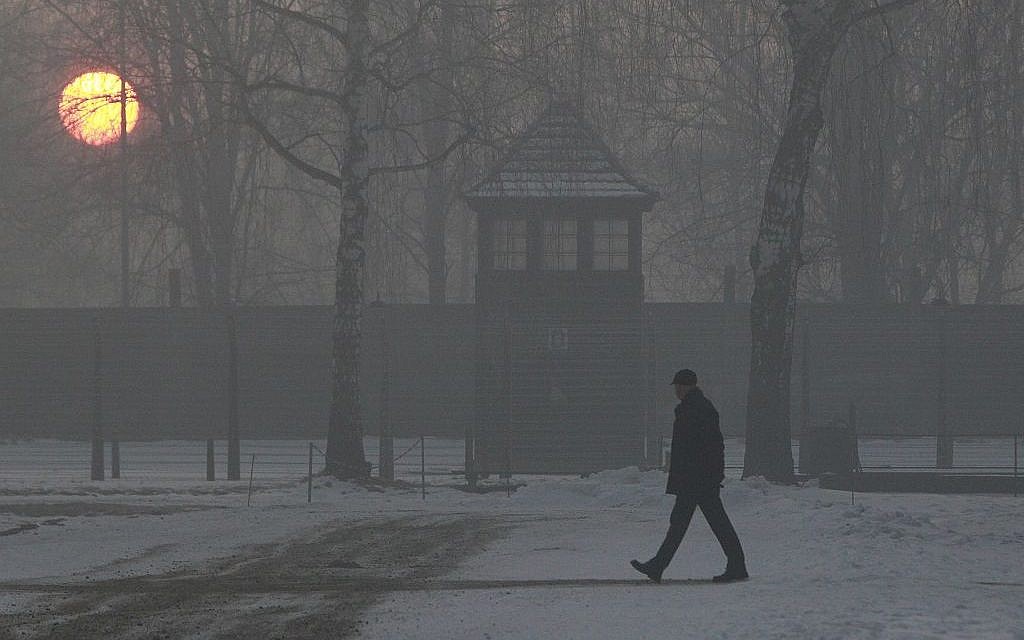 A man visits Auschwitz-Birkenau at sunrise on the 72nd anniversary of the liberation of the Nazi death camp, in Oswiecim, Poland, Friday, Jan. 27, 2017. (AP Photo/Czarek Sokolowski)