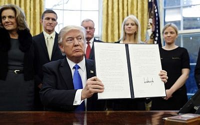 President Donald Trump holds up a signed Executive Order in the Oval Office of the White House, Saturday, Jan. 28, 2017 in Washington. (AP Photo/Alex Brandon) President Donald Trump holds up a signed Executive Order in the Oval Office of the White House, Saturday, Jan. 28, 2017 in Washington. (AP Photo/Alex Brandon)