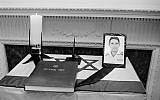 A photo of Israeli Col. Yosef Alon and a visitors book sit on a flag-draped memorial table at the Israeli embassy in Washington, July 1, 1973.  (AP Photo/stf)