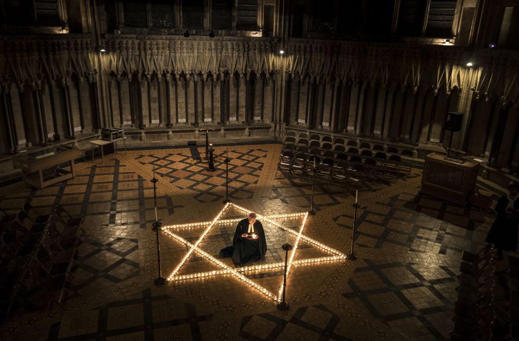 Canon Chancellor Christopher Collingwood helps light one of 600 candles in the shape of the Star of David to commemorate Holocaust Memorial Day at York Minster, York,, England, Thursday, Jan. 26, 2017. (Danny Lawson/PA via AP) Canon Chancellor Christopher Collingwood helps light one of 600 candles in the shape of the Star of David to commemorate Holocaust Memorial Day at York Minster, York,, England, Thursday, Jan. 26, 2017. (Danny Lawson/PA via AP)