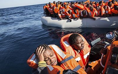 A migrant reacts on being rescued by the MV Aquarius, after 191 people and two corpses were recovered Friday Jan. 13, 2017, from international waters in the Mediterranean Sea about 22 miles north of Sabrata, Libya. (AP Photo/Sima Diab)