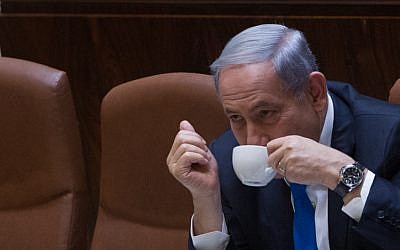Prime Minister Benjamin Netanyahu seen drinking coffee during a plenum session in the assembly hall of the Israeli parliament on June 17, 2015. (Miriam Alster/FLASH90)
