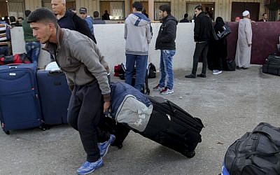 Palestinians wait for a travel permit to cross into Egypt through the Rafah border crossing on November 14, 2016, in the southern Gaza Strip. (Abed Rahim Khatib/Flash90)