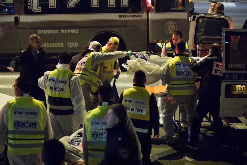 Zaka rescue personnel carry the bodies of family members at the scene where a woman and four children were killed in a fire at an apartment in Jerusalem on Sunday, January 1, 2017, in what may have been caused by a severe case of post-partum depression (Yonatan Sindel/Flash 90) Zaka rescue personnel carry the bodies of family members at the scene where a woman and four children were killed in a fire at an apartment in Jerusalem on Sunday, January 1, 2017, in what may have been caused by a severe case of post-partum depression (Yonatan Sindel/Flash 90)