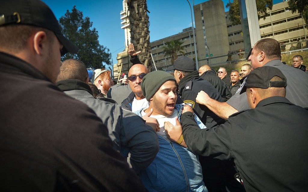 Following the conviction at of IDF Sgt. Elor Azaria for the manslaughter of a Palestinian attacker, police detain a demonstrator during a protest in support of  the soldier, outside the courtroom in the Kirya military base, Tel Aviv, January 4, 2017. (Flash90)