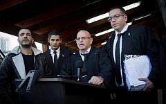 Attorneys Ilan Katz, center, and Eyal Besserglick, right, the legal team of IDF Sgt. Elor Azaria speak to press at the Kirya military base in Tel Aviv following a verdict on January 4, 2017. (Miriam Alster/FLASH90)