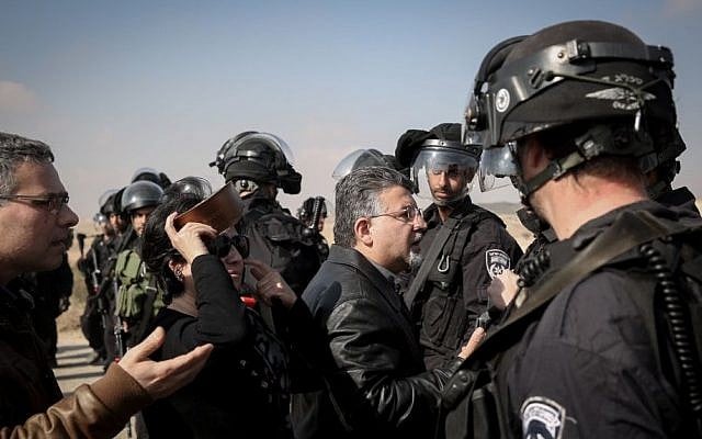 Arab MKs argue with Israeli police standing guard during demolition of homes in the Bedouin village of Umm al-Hiran in the Negev desert, Southern Israel, January 18, 2017. (Hadas Parush/Flash90) Arab MKs argue with Israeli police standing guard during demolition of homes in the Bedouin village of Umm al-Hiran in the Negev desert, Southern Israel, January 18, 2017. (Hadas Parush/Flash90)