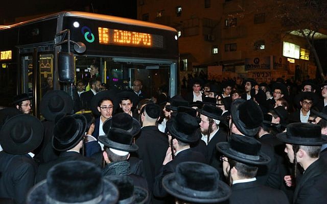 Ultra-Orthodox men block a road as they protest against the jailing of a Jewish seminary student who failed to comply with a national service recruitment order, in Beit Shemesh, January 17, 2017. (Yaakov Lederman/Flash90) 