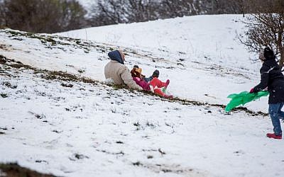 Israelis play in the snow in the Golan Heights, on January 28, 2017 (Basel Awidat/Flash90)