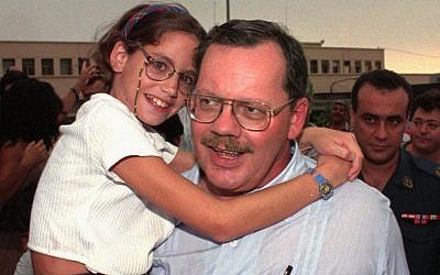 In this Aug. 5, 1996, file photo, Terry Anderson carries his daughter Sulome, 11, as they leave Beirut airport on his first trip back to Lebanon since his release in December 1991. (AP Photo/Saleh Rifai, File)