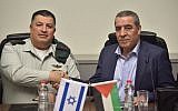 File: Then-coordinator of government activities in the territories (COGAT) Maj. Gen. Yoav Mordechai, left, and the Palestinian Authority’s Civil Affairs Minister Hussein al-Sheikh sign an agreement to revitalize the Israeli-Palestinian Joint Water Committee, January 15, 2017. (Courtesy COGAT)
