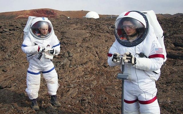 In this May 23, 2014 photo provided by the University of Hawaii, Lucie Poulet, right, uses a geotechnical tool while Annie Caraccio records the data during a previous study outside the domed structure that will house six researchers for eight months in an environment meant to simulate an expedition to Mars, on Mauna Loa on the Big Island of Hawaii. (Ross Lockwood/University of Hawaii via AP) In this May 23, 2014 photo provided by the University of Hawaii, Lucie Poulet, right, uses a geotechnical tool while Annie Caraccio records the data during a previous study outside the domed structure that will house six researchers for eight months in an environment meant to simulate an expedition to Mars, on Mauna Loa on the Big Island of Hawaii. (Ross Lockwood/University of Hawaii via AP)